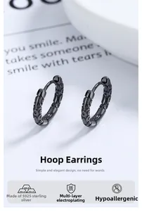 Macro view of 925 sterling silver hoop earrings with black Sun Wukong pattern