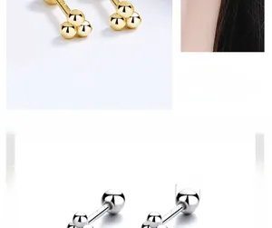 Macro detail of 3mm polished silver and gold sphere stud earrings with size parameters