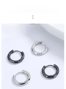 Close-up of 925 sterling silver hoop earrings with vintage hollow carved patterns