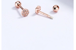 Detail of S925 rose gold earrings with pave-set zircons and secure screw ball back closure