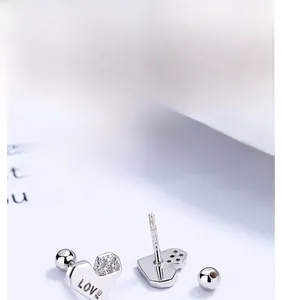 Close-up of S925 sterling silver heart stud earring with LOVE engraving and zircon stone