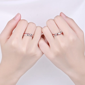 925 silver couple rings with red enamel cross lines shown in a hand-holding pose