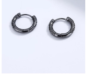 Macro detail of black 925 sterling silver hoop earrings with vintage cloud engravings