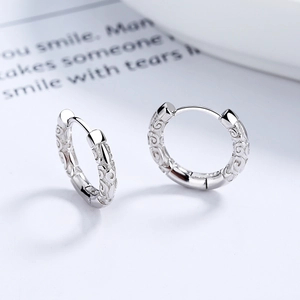925 sterling silver huggie earrings with vintage cloud pattern on polished surface
