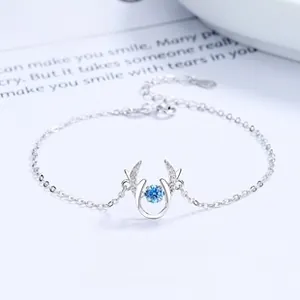 Close-up of S925 silver bracelet with rotating blue gemstone in reindeer pendant