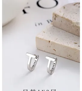Macro view of S925 sterling silver T-shaped geometric earrings with polished finish