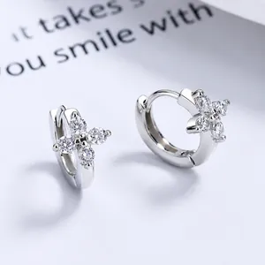 Minimalist S925 sterling silver flower earrings with white zircon on a simple background