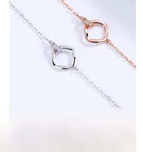 Macro detail of intertwined square pendants with cubic zirconia and multi-layer plating
