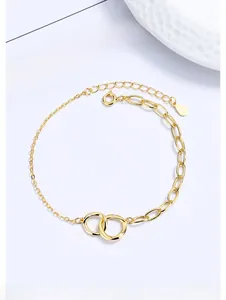 Detail of gold-plated 925 sterling silver interlocking double ring bracelet with crystals