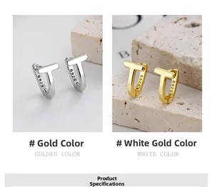 Macro detail of T-shaped earrings in gold and silver finish with S925 silver hallmarks