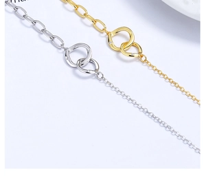 Macro detail of intertwined interlocking circles with pavé crystals on a mixed chain