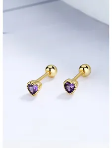 Detail of heart-shaped purple crystal stud earrings with gold screw back on paper