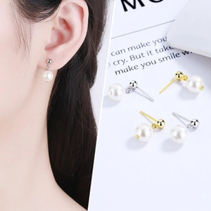 Detail of 925 sterling silver leaf pearl earrings in gold and silver finish options