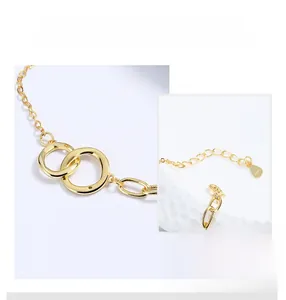 Close-up of interlocking rings on S925 sterling silver bracelet with gold plating