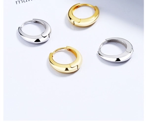 Details von dicken Gold- und Silber-Creolen in Wassertropfenform mit poliertem Finish