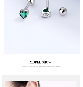 Detail of S925 sterling silver heart earrings with green zircon and screw ball back