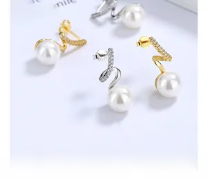Macro shot showing S925 sterling silver stamp and pearl detail on wave stud earrings