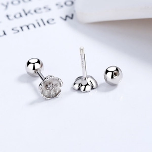 Macro detail of S925 sterling silver cherry blossom stud earrings with screw back ball