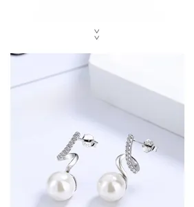 Close-up of S925 sterling silver wavy pearl earrings with sparkling zircon accents