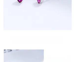 Macro detail of heart-shaped pink zircon earrings with 925 sterling silver screw back