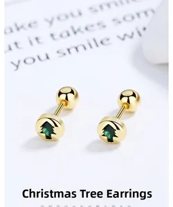 Detailed macro of golden Christmas tree stud earrings with green crystals and screw back