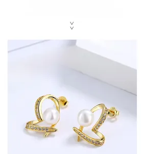 Detail of heart-shaped pearl earrings in S925 sterling silver with zircon stones