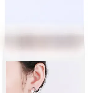 Detailed view of elegant silver-colored drop earrings with tiny diamonds and white pearls
