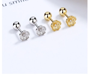 Close-up of cherry blossom stud earrings with matte texture and white zircon center