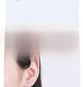 Detail of crown screw-back silver earring showing secure fit for comfortable all-day wear