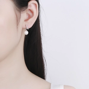 Elegant 925 sterling silver wave earrings with white pearls and sparkling cubic zirconia