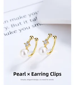Detail of 925 silver pearl ear cuff with gold plating and sparkling crystal accent