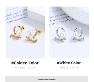 Detailed comparison of golden and silver heart-shaped pearl earrings with tiny diamonds