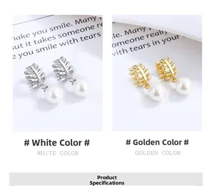 Detail of silver and gold leaf earrings featuring high-luster pearl drop charms