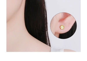 Close-up detail of silver cherry blossom stud earring with centered sparkling zircon stone