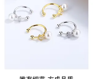 Detailed view of 925 silver pearl ear cuffs with sparkling zircon in gold and silver finish