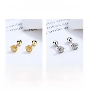 Macro detail of 925 sterling silver cherry blossom screw back studs in gold and silver