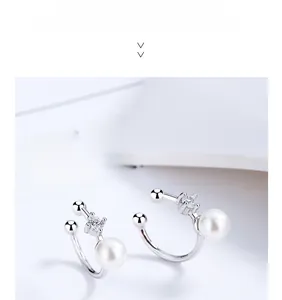 Detail of 925 sterling silver pearl ear cuff with cubic zirconia in a minimalist design