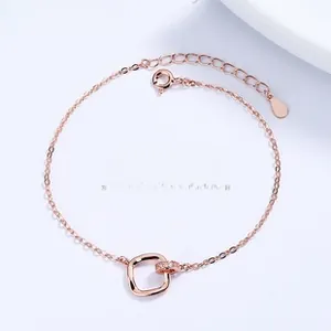 Detail of rose gold intertwined Mobius ring bracelet with pavé cubic zirconia accents