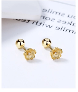 Detail of gold flower stud earrings with white zircon center and secure ball screw back