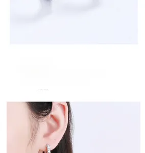 Macro shot of micro-pave cubic zirconia inlay on silver minimalist hoop earrings