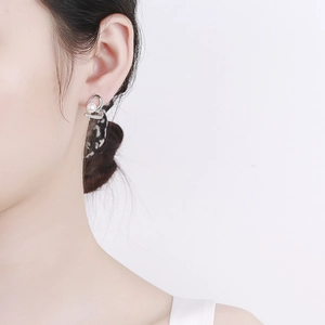 Elegant 925 sterling silver heart earrings with white freshwater pearls on model