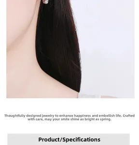 Detailed view of sterling silver cubic zirconia floral earrings on a model's ear