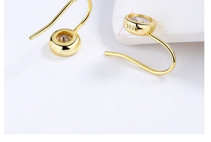 Macro view of S925 sterling silver stamp on gold plated bezel set zircon earrings