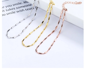Close-up of S925 sterling silver minimalist thin chain bracelet in gold and rose gold