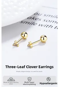 Detailed macro of gold plated S925 sterling silver clover studs with shiny cubic zirconia