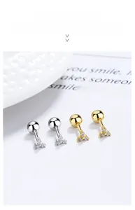 Macro view of tiny zircon clover screw-back earrings in silver and gold 925 sterling silver
