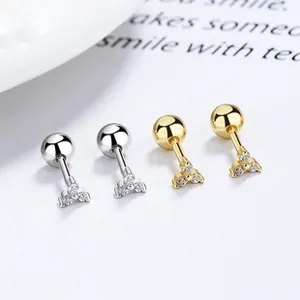 Close-up of triangular zircon silver and gold earrings with secure ball screw backs