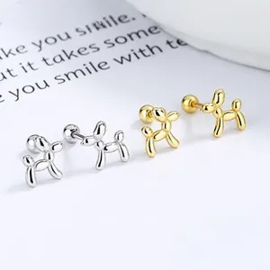 Detailed view of silver and gold balloon dog stud earrings with secure screw backs