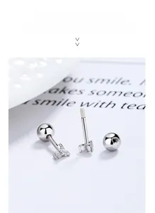 Macro shot of 925 silver clover stud earrings with three zircons and screw ball back