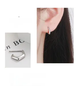 Detail view of 925 sterling silver geometric C-shape earrings with silver backings